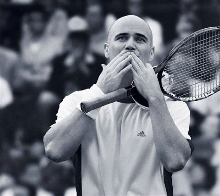 Andre Agassi in a black cowboy hat smiles with Brooke Shields in a red-checkered shirt
