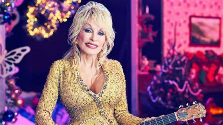 Dolly Parton visiting "Late Show with David Letterman" in 2012. She's wearing a black outfit with her signature black fingerless gloves.