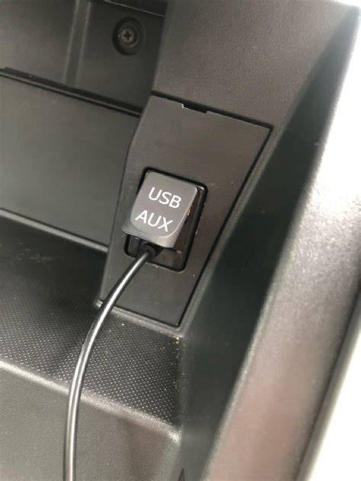 How do I use the AUX button in my car?