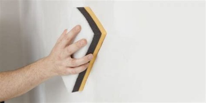 How do you smooth drywall mud with a sponge?