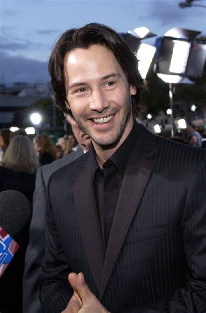 Keanu Reeves smiling while he attends a a culinary demonstration during the 2023 BottleRock Napa Valley festival.