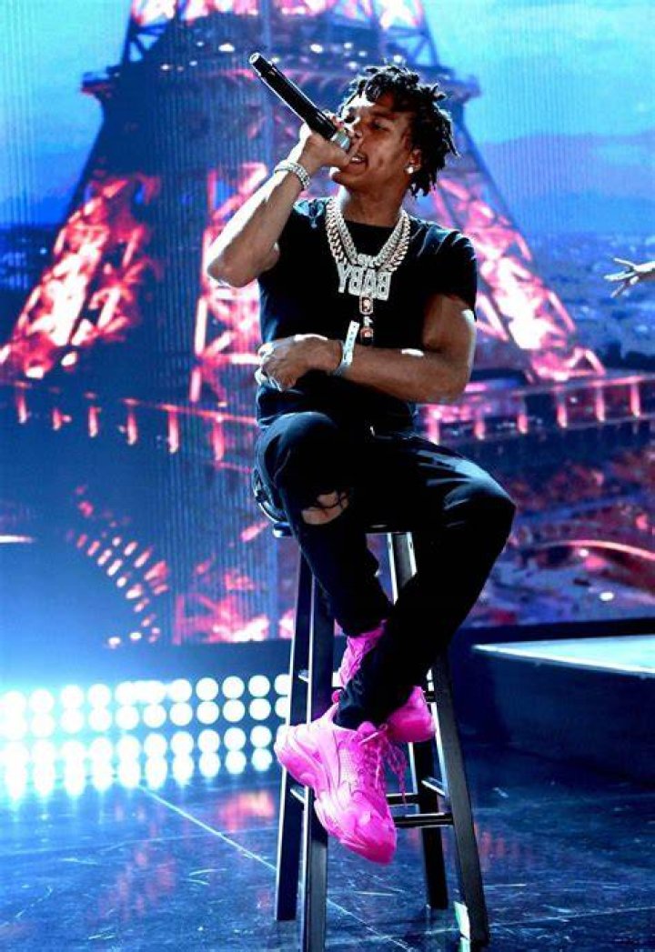 Lil Baby performing on a stage in Atlanta