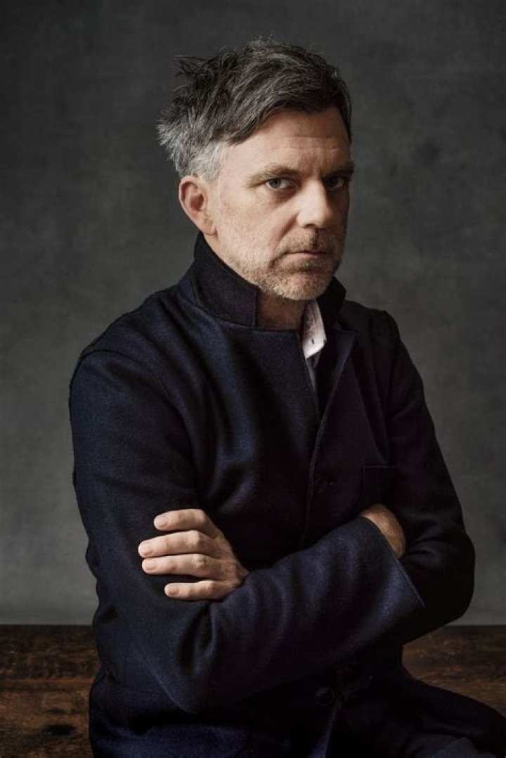 Paul Thomas Anderson image for article about 'Licorice Pizza' Asian gag with a white collared shirt in front of a step and repeat