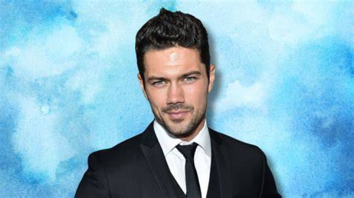 Ryan Paevey in a white shirt in front of a white background