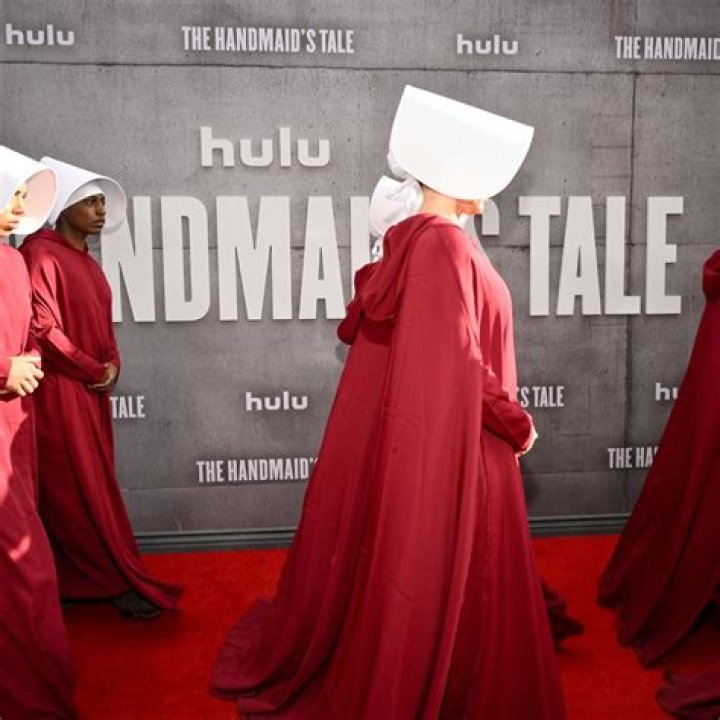 The Handmaid's Tale star Samira Wiley wears a low-cut black blazer and black earrings.