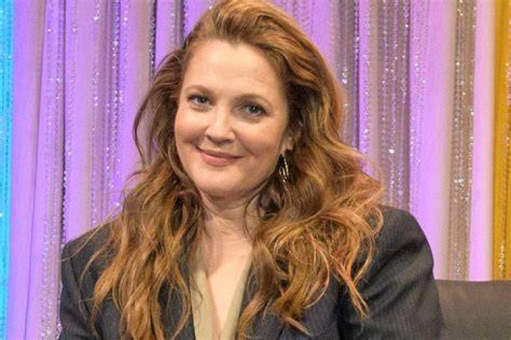 TV host Drew Barrymore wears a birthday hat on her birthday as she picks friends up from the airport