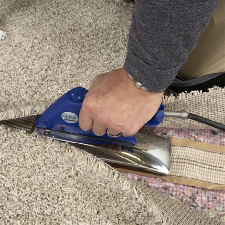 What does a carpet seaming iron do?